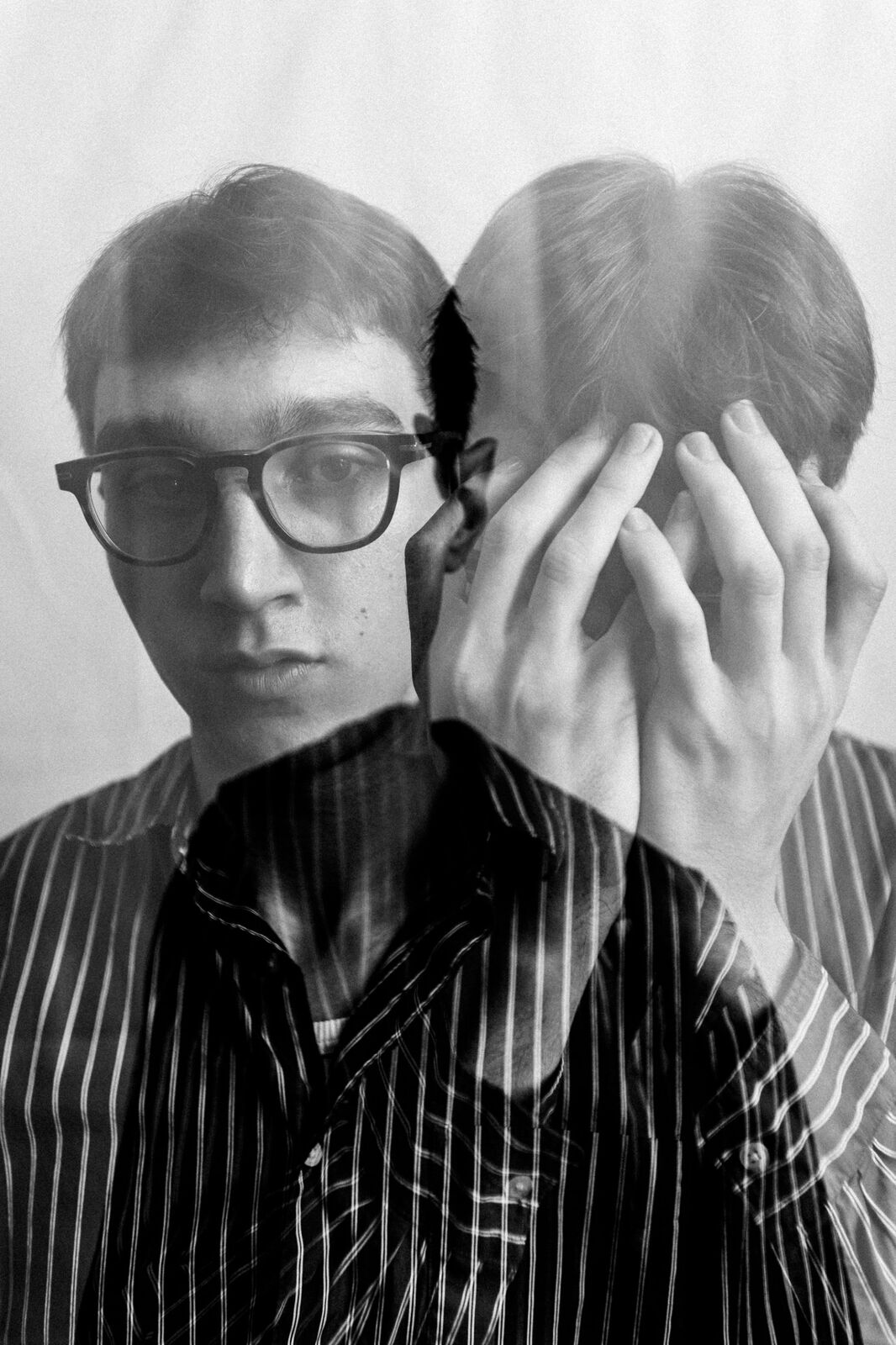 Double-exposure portrait in a striped shirt